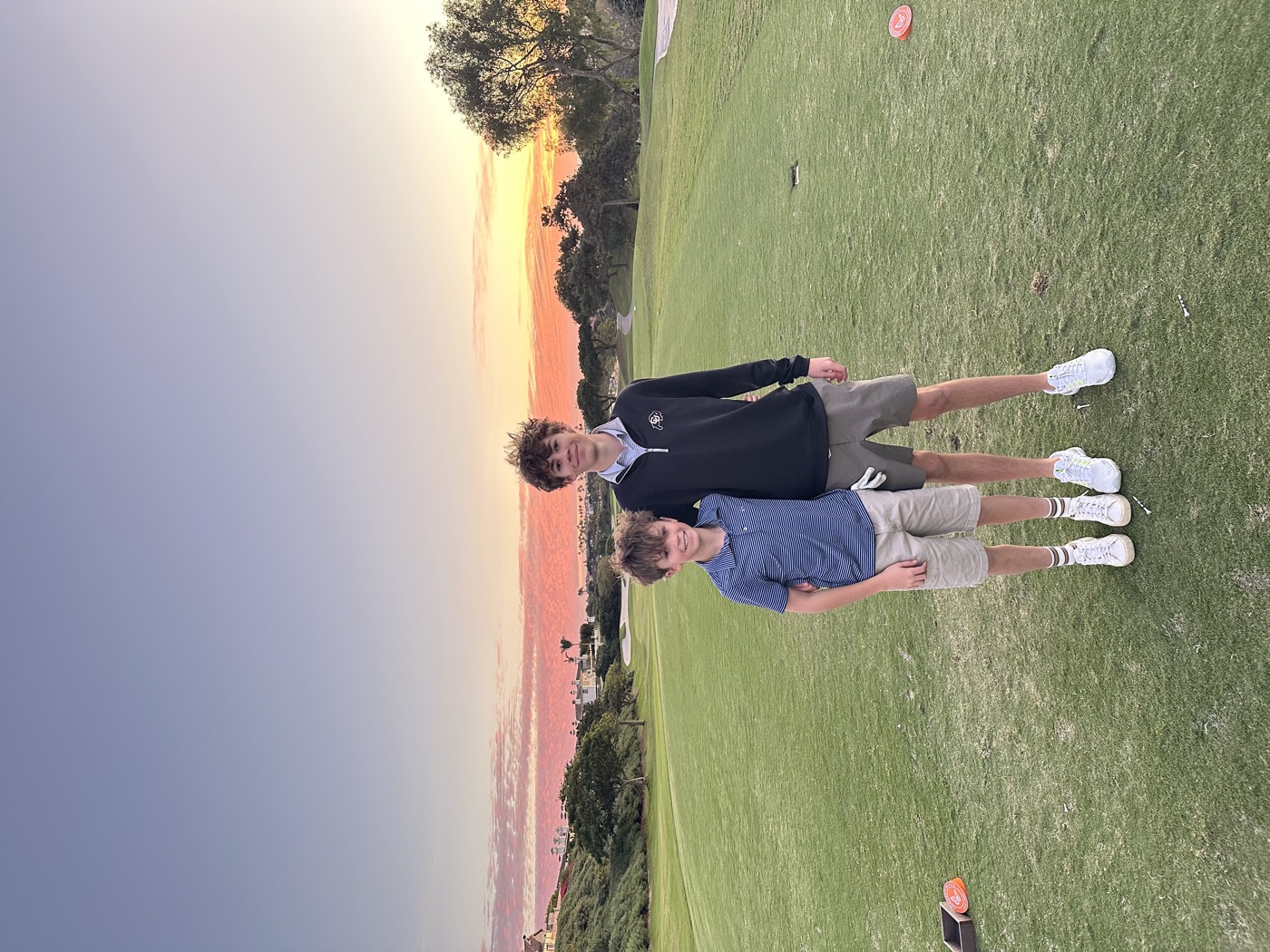 Noah Winski on the golf course at sunset